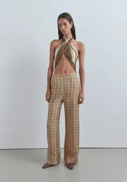 Viktoria & Woods Chauffeur Trouser In Gold Monogram for rent on The Volte - main image